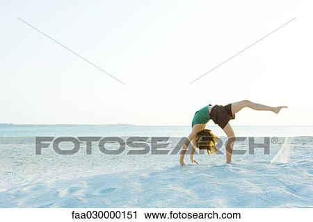 Girl doing gymnastics on beach View Large Photo Image Stock Image - Girl doing gymnastics on beach. Fotosearch