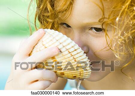 Girl drinking out of seashell, close-up View Large Photo Image Stock Image - Girl drinking out of seashell, close-up. Fotosearch
