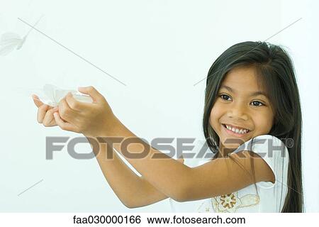 Girl holding fake butterflies View Large Photo Image Stock Photograph - Girl holding fake butterflies. Fotosearch