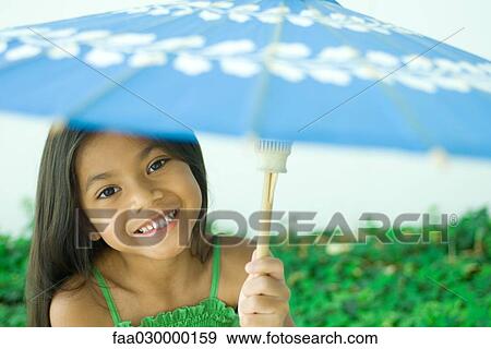 Girl holding up parasol View Large Photo Image Stock Photo - Girl holding up parasol. Fotosearch