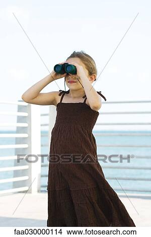 Girl looking through binoculars View Large Photo Image Picture - Girl looking through binoculars. Fotosearch