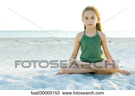 Girl sitting cross-legged on beach, full length View Large Photo Image Stock Image - Girl sitting cross-legged on beach, full length. Fotosearch