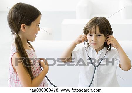 Little boy listening to girl's heart with stethoscope View Large Photo Image Stock Photo - Little boy listening to girl's heart with stethoscope. Fotosearch