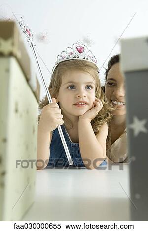 Little girl dressed as a princess, hand under chin, looking away View Large Photo Image Stock Photography - Little girl dressed as a princess, hand under chin, looking away. Fotosearch