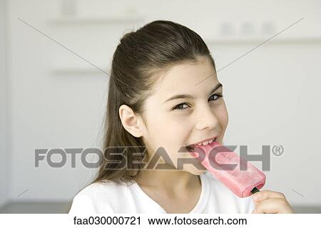 Little girl eating popsicle, smiling at camera View Large Photo Image Stock Image - Little girl eating popsicle, smiling at camera. Fotosearch