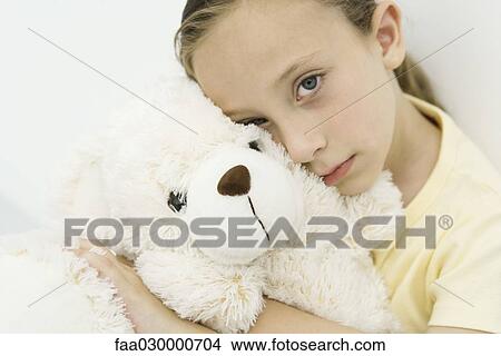 Little girl hugging teddy bear, looking at camera, portrait View Large Photo Image Picture - Little girl hugging teddy bear, looking at camera, portrait. Fotosearch