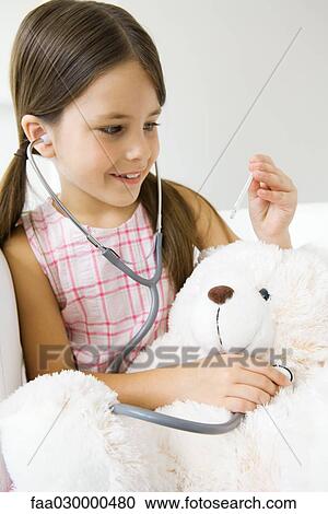 Little girl listening to teddy's bear's heart with stethoscope, looking at thermometer View Large Photo Image Stock Image - Little girl listening to teddy's bear's heart with stethoscope, looking at thermometer. Fotosearch