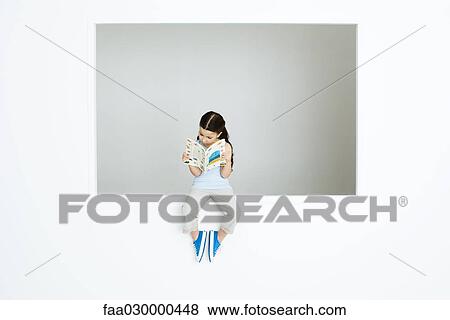 Little girl sitting on ledge, reading book View Large Photo Image Stock Photo - Little girl sitting on ledge, reading book. Fotosearch
