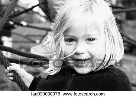 Little girl, smiling at camera, portrait, black and white View Large Photo Image Stock Photo - Little girl, smiling at camera, portrait, black and white. Fotosearch