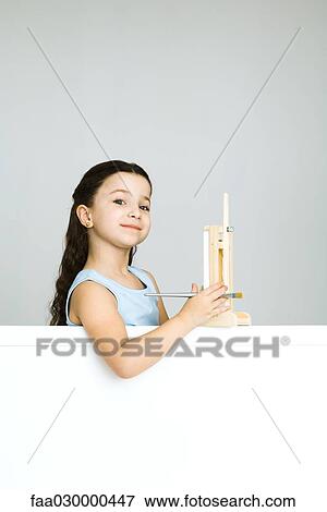 Little girl with small easel, smiling at camera View Large Photo Image Stock Photo - Little girl with small easel, smiling at camera. Fotosearch