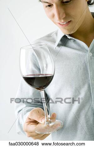 Man holding glass of red wine, cropped view View Large Photo Image Stock Photo - Man holding glass of red wine, cropped view. Fotosearch