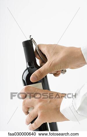 Man opening wine bottle, close-up, cropped view of hands View Large Photo Image Stock Image - Man opening wine bottle, close-up, cropped view of hands. Fotosearch