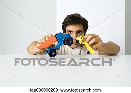 Man playing with toy trucks View Large Photo Image Stock Photo - Man playing with toy trucks. Fotosearch