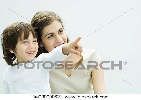 Mother and son together, boy pointing, both smiling View Large Photo Image Stock Image - Mother and son together, boy pointing, both smiling. Fotosearch