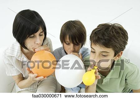 Mother and two sons inflating balloons View Large Photo Image Stock Image - Mother and two sons inflating balloons. Fotosearch