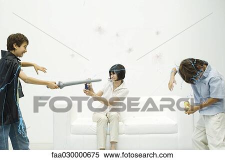 Mother and two sons playing with spray string, smiling View Large Photo Image Stock Photography - Mother and two sons playing with spray string, smiling. Fotosearch