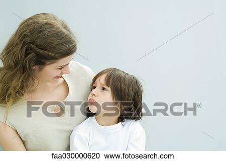 Mother and young son looking at each other, boy frowning View Large Photo Image Stock Image - Mother and young son looking at each other, boy frowning. Fotosearch