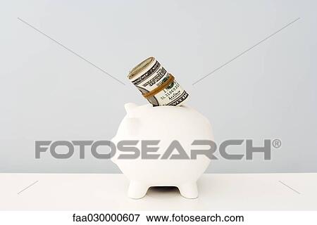 Piggy bank with wad of money sticking out View Large Photo Image Stock Photo - Piggy bank with wad of money sticking out. Fotosearch