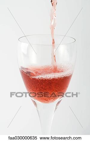 Rose wine pouring into glass, close-up View Large Photo Image Stock Photography - Rose wine pouring into glass, close-up. Fotosearch
