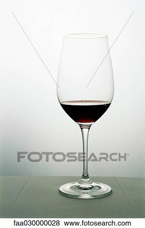 Small amount of red wine in wineglass View Large Photo Image Stock Photo - Small amount of red wine in wineglass. Fotosearch