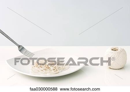 Stock Photo - String imitating spaghetti on plate. Fotosearch