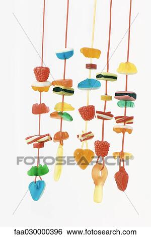 Stock Photograph - Strings of colorful candy. Fotosearch