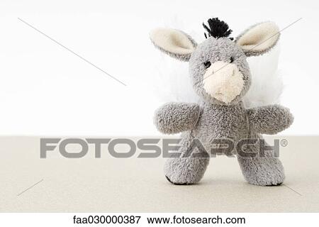 Stock Photo - Stuffed toy donkey with wings, close-up. Fotosearch