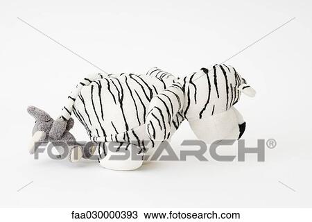 Stuffed toys, elephant pulling tiger's tail View Large Photo Image Stock Image - Stuffed toys, elephant pulling tiger's tail. Fotosearch