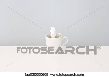 Sugar cubes stacked inside coffee cup View Large Photo Image Stock Photo - Sugar cubes stacked inside coffee cup. Fotosearch