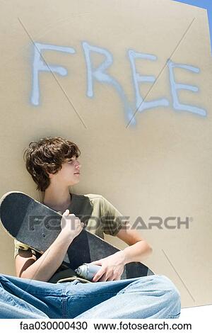 Teen boy holding skateboard and spray paint can, under the word "free" on wall View Large Photo Image Stock Image - Teen boy holding skateboard and spray paint can, under the word "free" on wall. Fotosearch