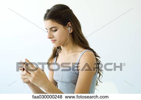 Teen girl listening to MP3 player, side view View Large Photo Image Stock Photo - Teen girl listening to MP3 player, side view. Fotosearch