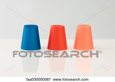 Three colored cups, upside down View Large Photo Image Stock Photo - Three colored cups, upside down. Fotosearch