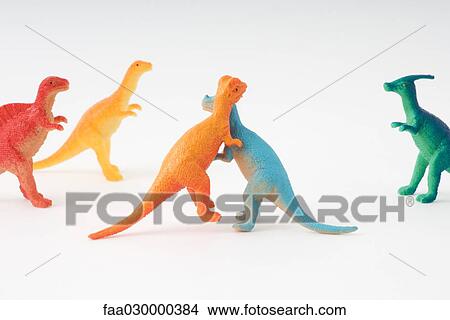Toy dinosaurs fighting while others watch View Large Photo Image Picture - Toy dinosaurs fighting while others watch. Fotosearch