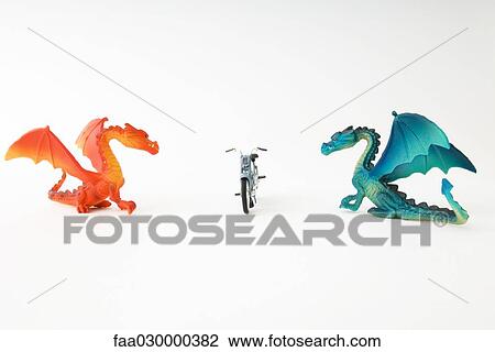 Toy dragons facing each other with toy motorcyle between them View Large Photo Image Stock Image - Toy dragons facing each other with toy motorcyle between them. Fotosearch