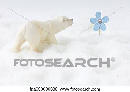 Toy polar bear in snow, looking at artificial flower View Large Photo Image Stock Image - Toy polar bear in snow, looking at artificial flower. Fotosearch