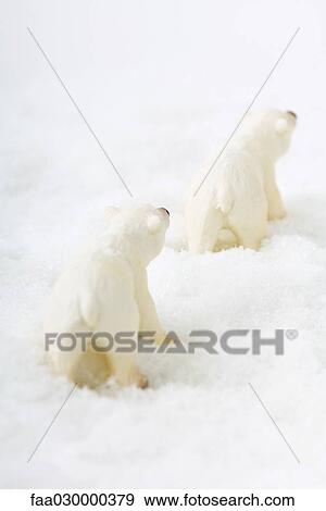 Stock Photo - Toy polar bears in snow, rear view. Fotosearch
