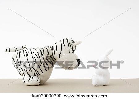 Toy tiger facing toy rabbit, close-up View Large Photo Image Stock Image - Toy tiger facing toy rabbit, close-up. Fotosearch
