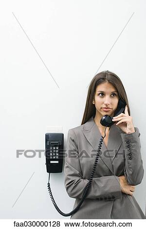 Well-dressed young female using phone View Large Photo Image Stock Photo - Well-dressed young female using phone. Fotosearch