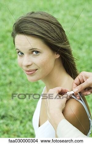 Woman adjusting teen girl's shoulder strap, girl smiling at camera, cropped vjew View Large Photo Image Picture - Woman adjusting teen girl's shoulder strap, girl smiling at camera, cropped vjew. Fotosearch