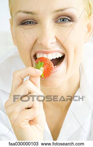 Woman biting into strawberry View Large Photo Image Stock Image - Woman biting into strawberry. Fotosearch