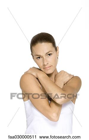 Woman folding arms across chest, looking at camera View Large Photo Image Stock Image - Woman folding arms across chest, looking at camera. Fotosearch