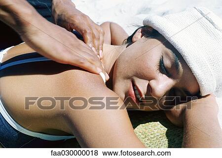 Woman having shoulders massaged on beach, close-up View Large Photo Image Stock Photo - Woman having shoulders massaged on beach, close-up. Fotosearch