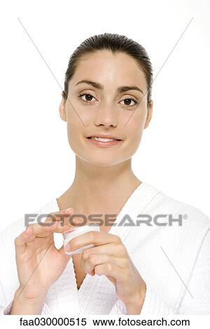 Woman holding moisturizer jar, smiling at camera View Large Photo Image Stock Photography - Woman holding moisturizer jar, smiling at camera. Fotosearch