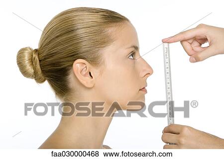 Woman in profile, face being measured by ruler View Large Photo Image Stock Photo - Woman in profile, face being measured by ruler. Fotosearch