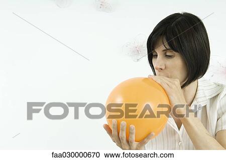 Woman inflating balloon View Large Photo Image Stock Image - Woman inflating balloon. Fotosearch