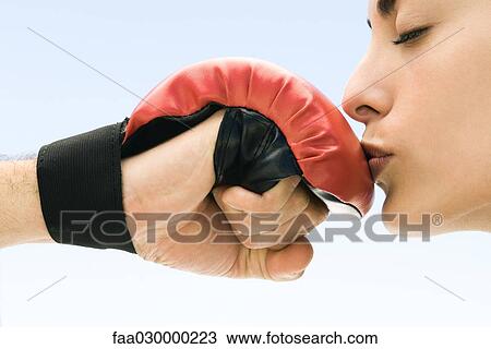 Woman kissing man's boxing glove, eyes closed, side view View Large Photo Image Stock Image - Woman kissing man's boxing glove, eyes closed, side view. Fotosearch