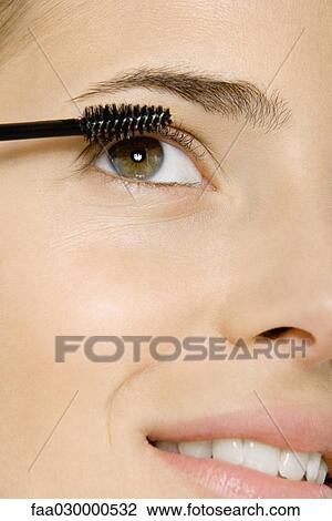 Woman putting on mascara, close-up of face View Large Photo Image Stock Image - Woman putting on mascara, close-up of face. Fotosearch