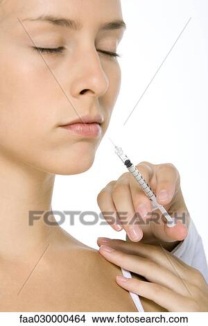 Woman receiving botox injection, eyes closed, close-up View Large Photo Image Picture - Woman receiving botox injection, eyes closed, close-up. Fotosearch