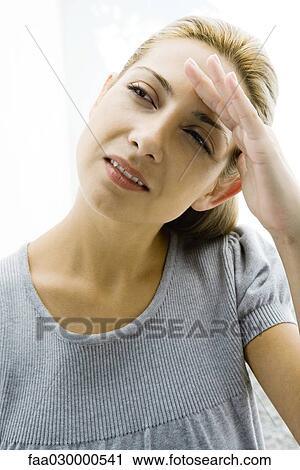 Woman shading her eyes, looking up, portrait View Large Photo Image Stock Image - Woman shading her eyes, looking up, portrait. Fotosearch