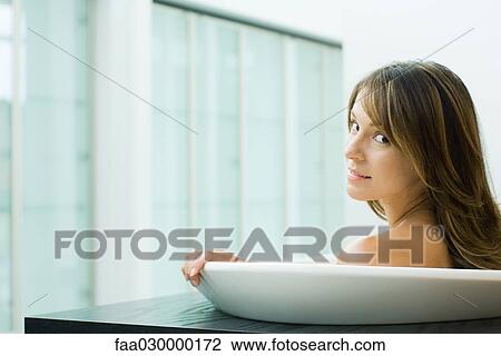 Woman taking bath, looking over shoulder at camera View Large Photo Image Stock Image - Woman taking bath, looking over shoulder at camera. Fotosearch